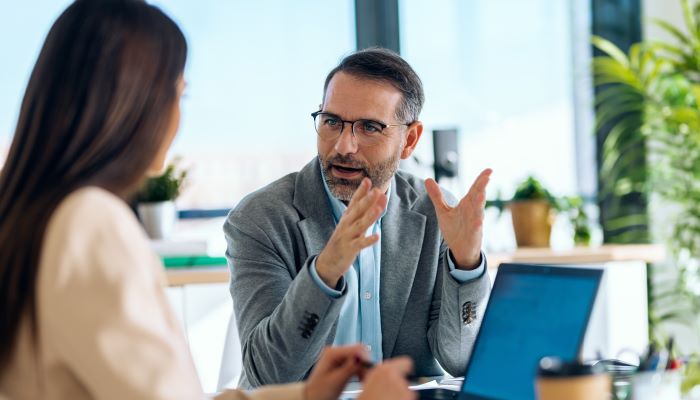 business people working together with laptop while talking 